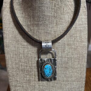 Kingman turquoise sterling silver tufa cast pendant set on old saddle string leather necklace